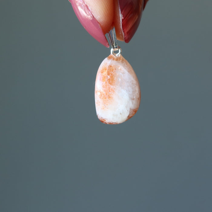 hand holding Sunstone Pendant Drop pendant