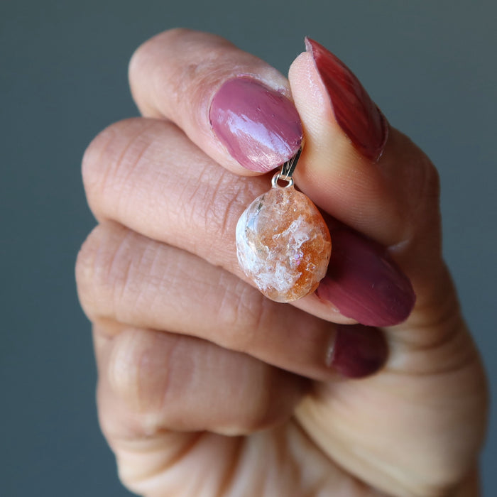 hand holding Sunstone Pendant Drop pendant