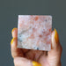 hand holding sunstone pyramid