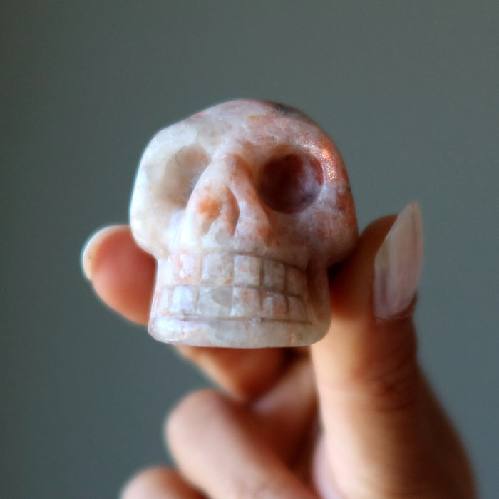 hand holding Sunstone Skull 