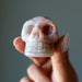 hand holding Sunstone Skull 