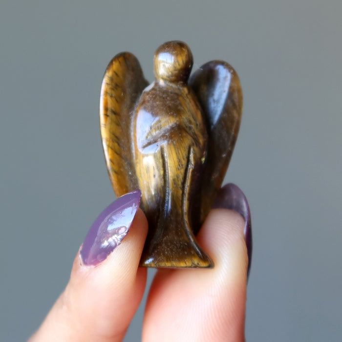 finger tips holding Tigers Eye Angel 