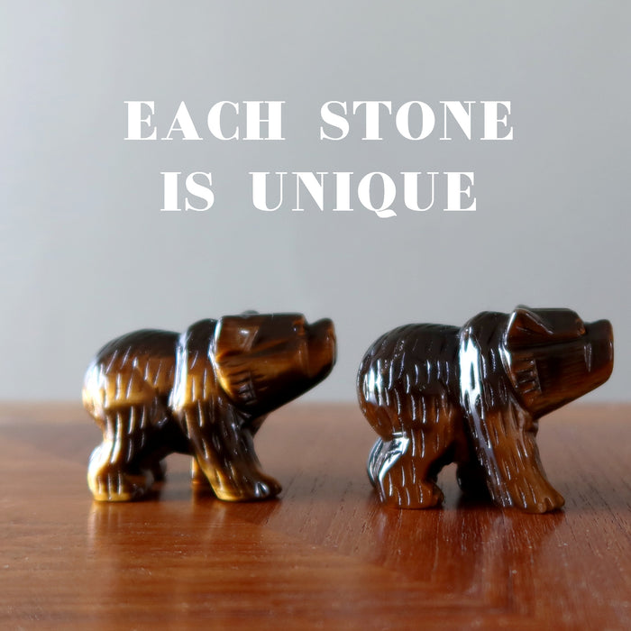 two finger tips holding Tigers Eye Bears