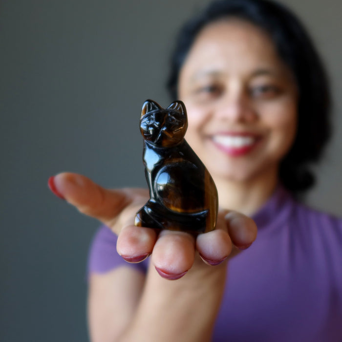 woman holding golden tigers eye cat