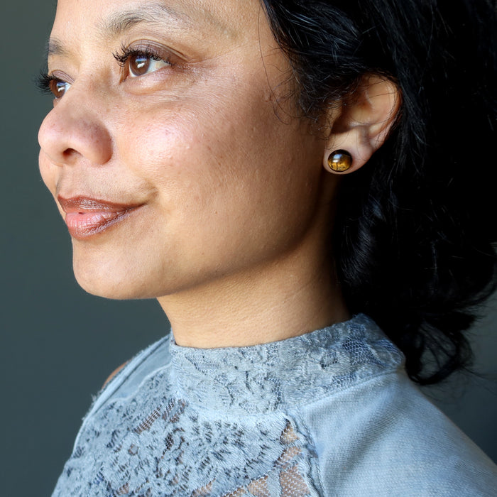 woman modeling tigers eye stud earrings