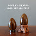 one Tigers Eye Egg on ring stand the orher on wood stand