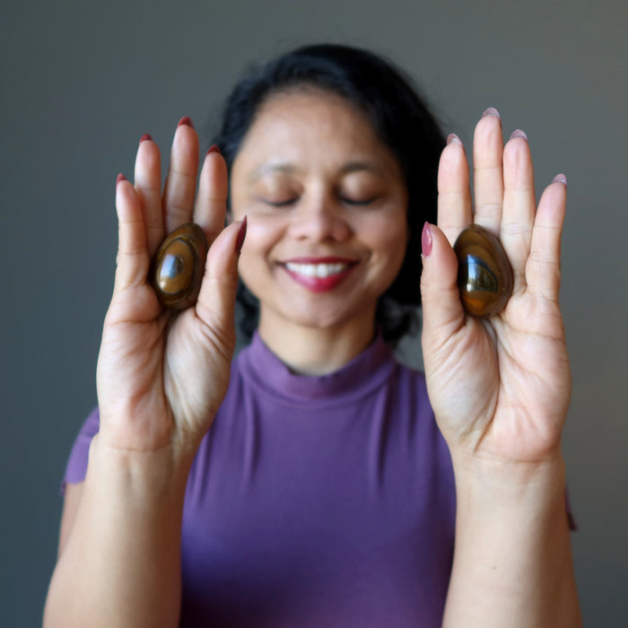sheila meditating with tigers eye eggs one on each palm 