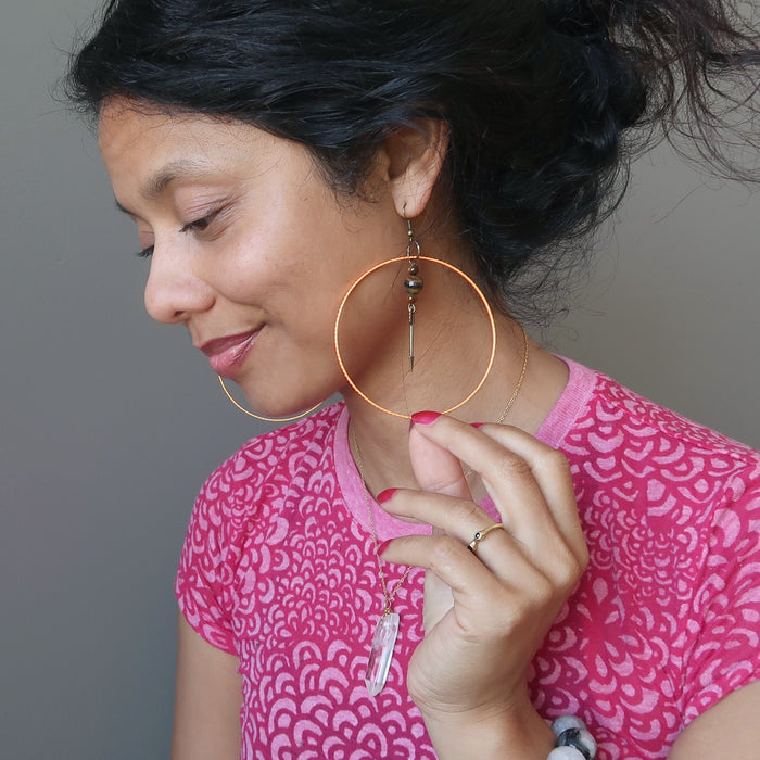 sheila of satin crystals wearing tigers eye arrow orange hoop earrings