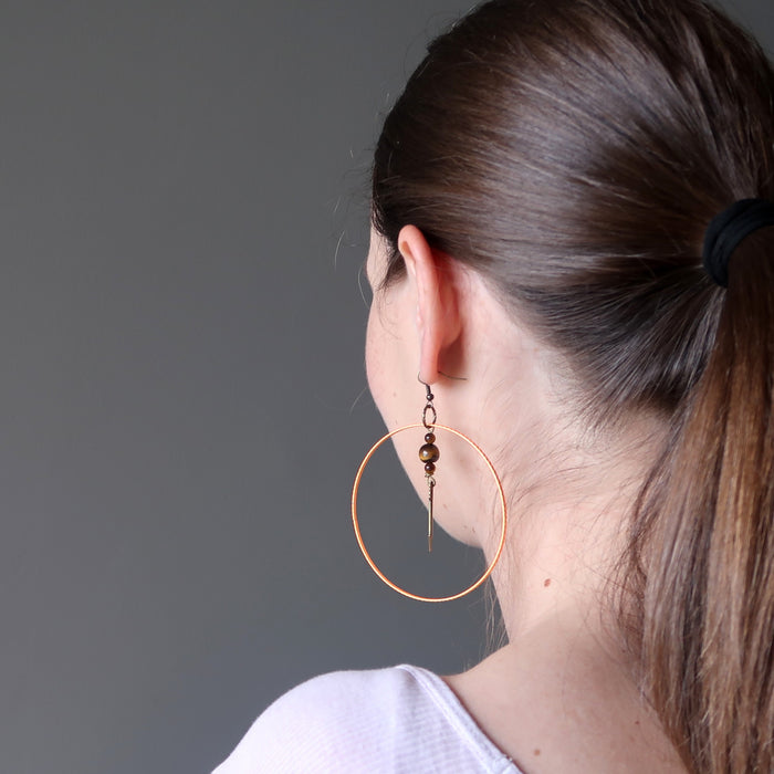 lucia of satin crystals wearing tigers eye arrow orange hoop earrings