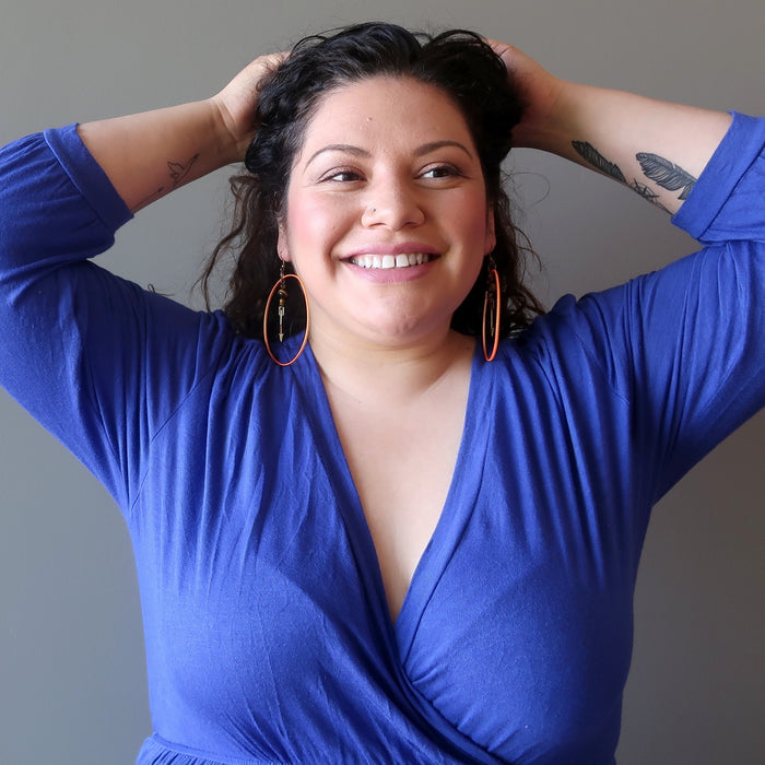 sotera of satin crystals wearing tigers eye arrow orange hoop earrings