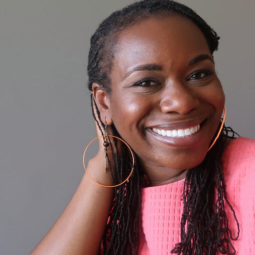 bridget of satin crystals wearing tigers eye arrow orange hoop earrings
