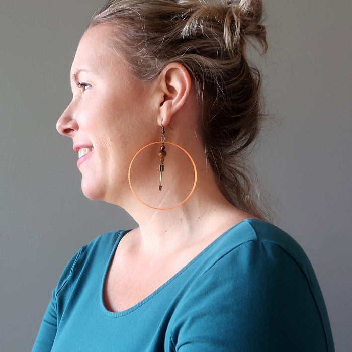 liz of satin crystals wearing tigers eye arrow orange hoop earrings