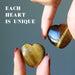 hand holding tigers eye heart set