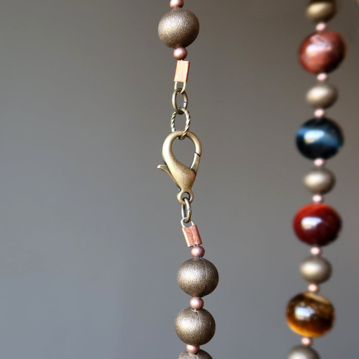 lobster claw clasp of golden, blue and red tigers eye on antiqued beaded necklace