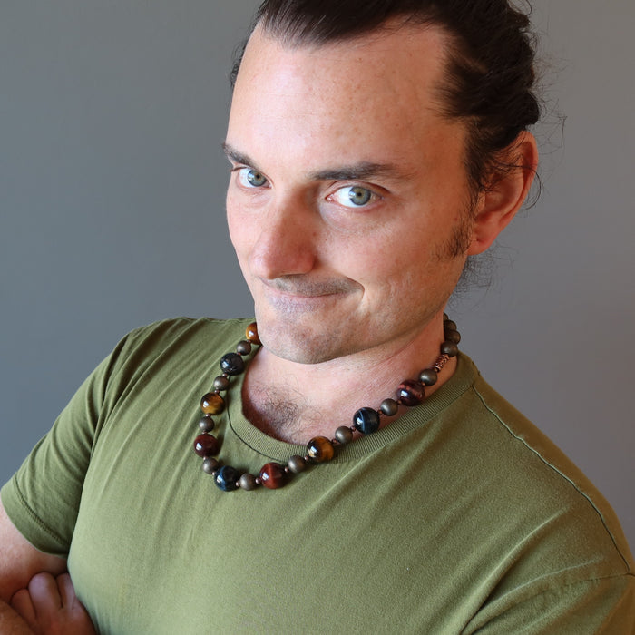 kendrick of satin crystals wearing golden, blue and red tigers eye on antiqued beaded necklace