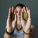 sheila of satin crystals holding two tigers eye slabs one on each hand
