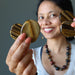 sheila of satin crystals holding two Tigers Eye Polished Slabs on each hand