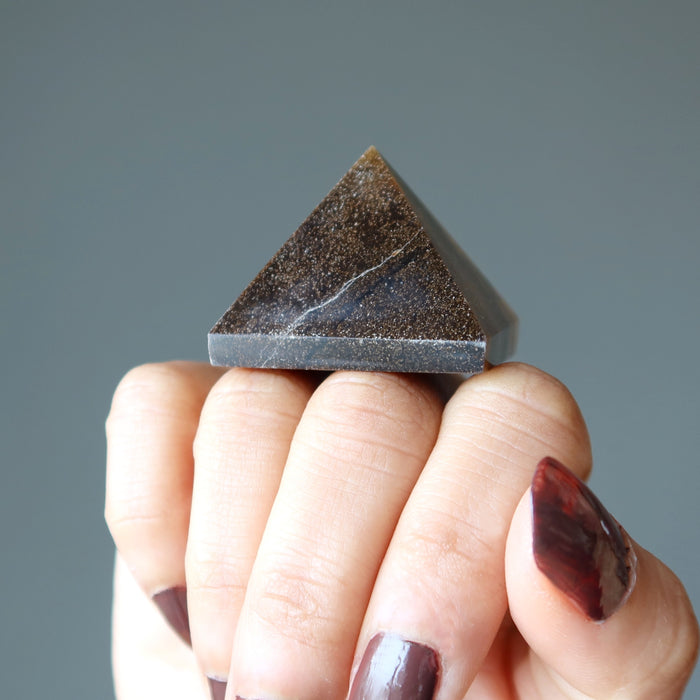 Tigers Eye Pyramid on the fist