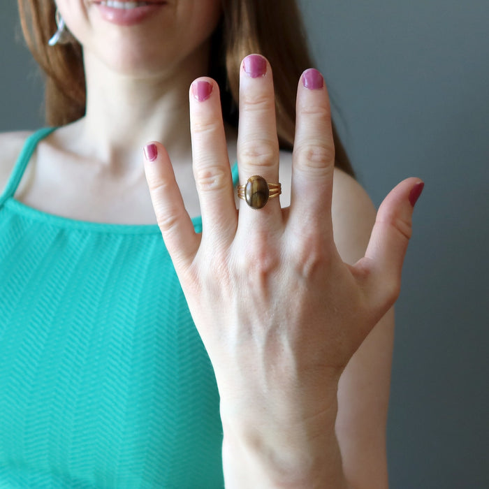female wearing tigers eye gold ring