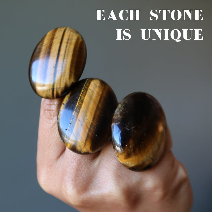 hand wearing tigers eye rings showing each is unique