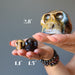 hands holding 3 brown tigers eye skulls