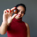 woman  holding red tigers eye sphere