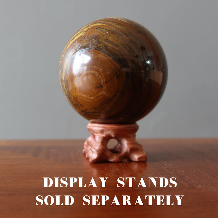 displaying Tigers Eye Sphere with Hematite on wood stand