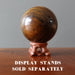 displaying Tigers Eye Sphere with Hematite on wood stand