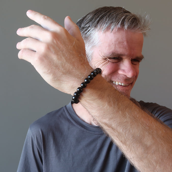 ryan of satin crystals wearing a black tourmaline bracelet