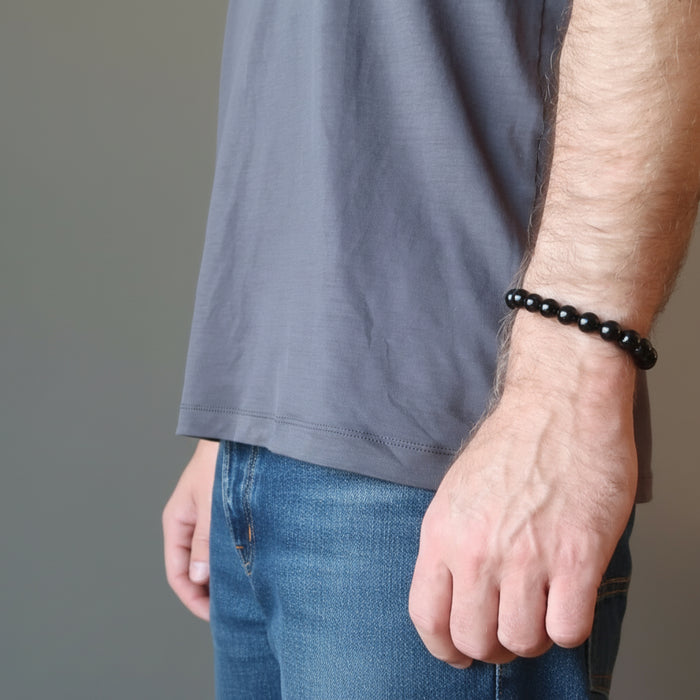 man wearing a black tourmaline bracelet
