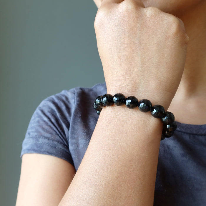 hand wearing faceted black tourmaline bracelet