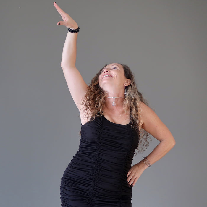 aleks of satin crystals striking a pose wearing two faceted black tourmaline stretch bracelets