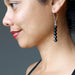 female wearing faceted black tourmaline earring