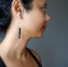 female wearing faceted black tourmaline earring