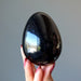 hand holding black tourmaline egg