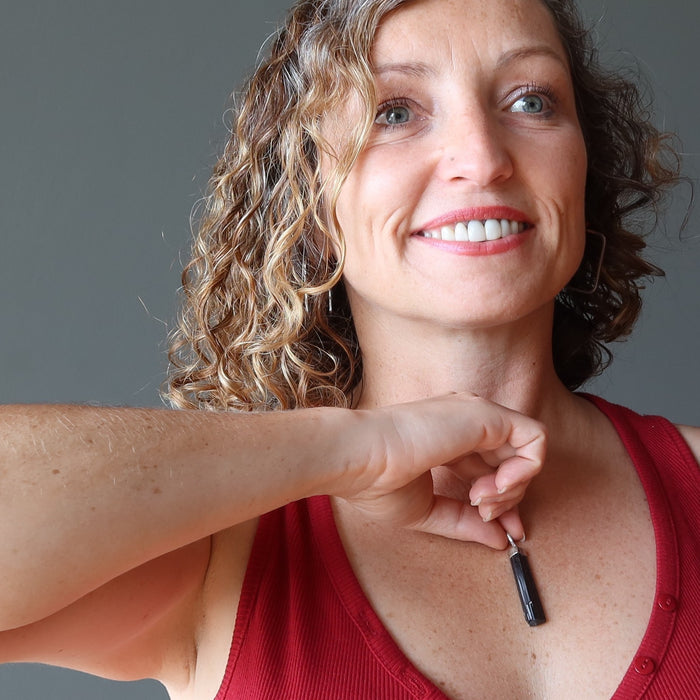 female moldel holding Raw Black Tourmaline Pendant on chest