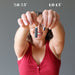 female model holding a Raw Black Tourmaline Pendant on each hand