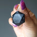 hand holding black tourmaline hexagon pendant