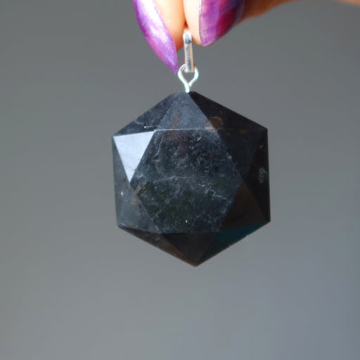 hand holding black tourmaline hexagon pendant