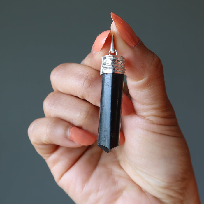 hand holding Black Tourmaline point Pendant 