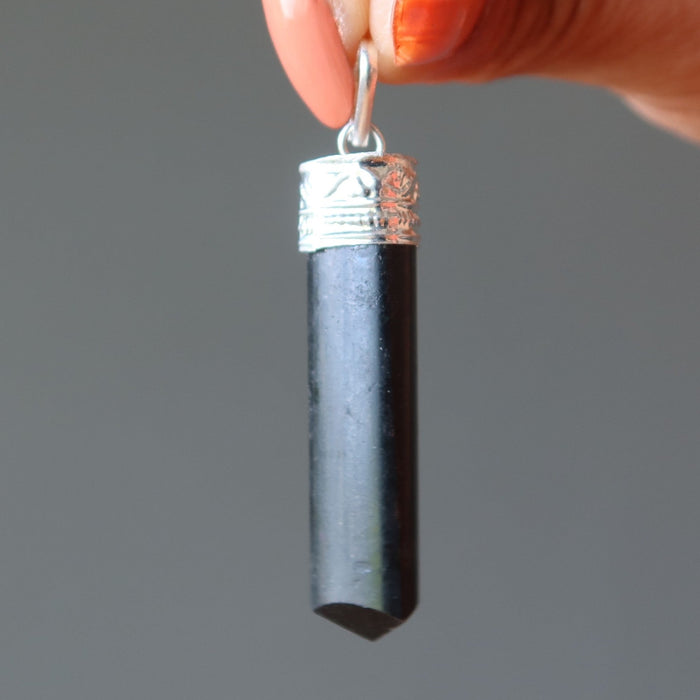 holding Black Tourmaline point Pendant 