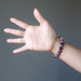 A round beaded pink Tourmaline bracelet on a model's hand