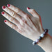 A round beaded pink Tourmaline bracelet on a model's hand