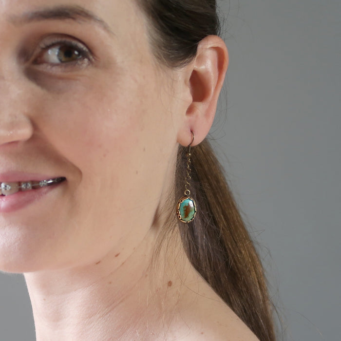 female model wearing Blue Oval Antiqued Leaf Turquoise Earrings
