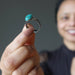 sheila of satin crystals holding turquoise ring
