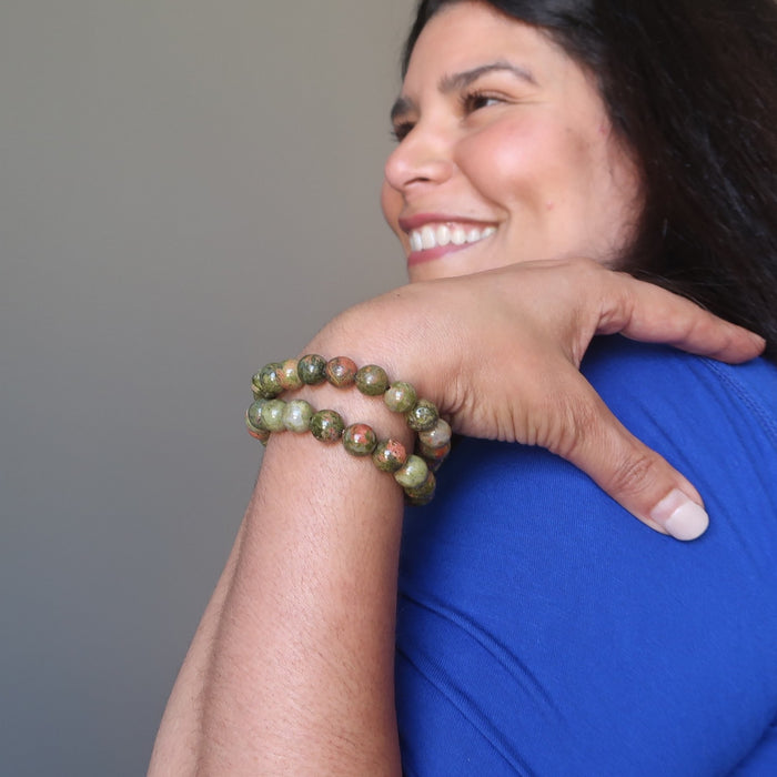 jaren of satin crystals wearing pink and green round unakite beaded stretch bracelets