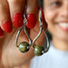 sheila of satin crystals holding unakite earrings