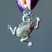 finger tips holding partly silver and Unakite frog Pendant 
