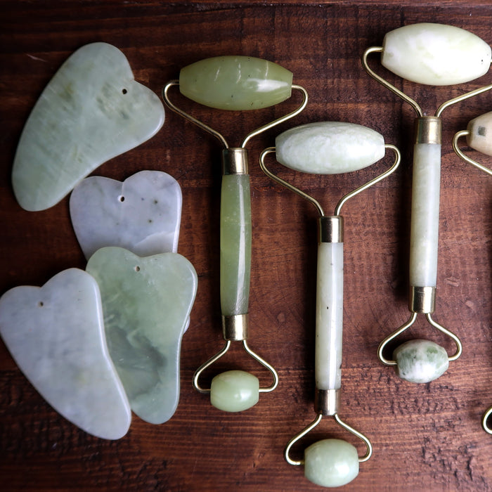 a selection of jade scrapers and rollers showing the difference in colors